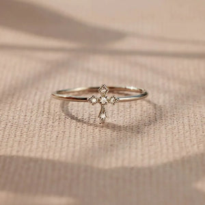 Delicate diamond cross ring in silver with sparkling cubic zirconia accents.
