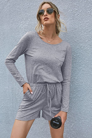 Gray jersey pocket romper with long sleeves, drawstring waist, and shorts.