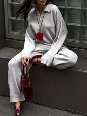 Grey knit polo collar sweater and wide-leg pants set with button detail.