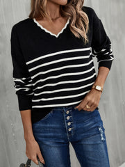 Black and white striped knit sweater with scalloped trim V-neck and long sleeves.
