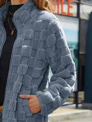 Textured grid zip-up jacket in grey fleece with a mock neck and side pockets.