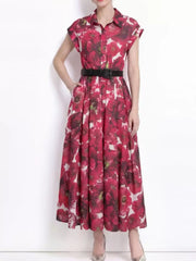 Red botanical print collared midi dress with button-down front and black belt.