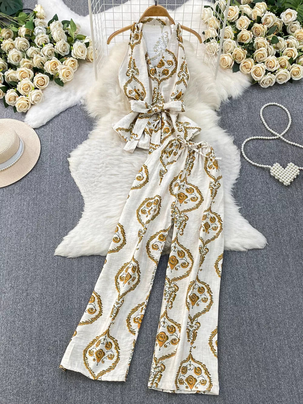 Tropical print two-piece set with belted detail, white with gold pattern, polyester.