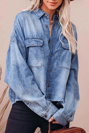 Light wash denim oversized shirt with raw hemline and two chest pockets.