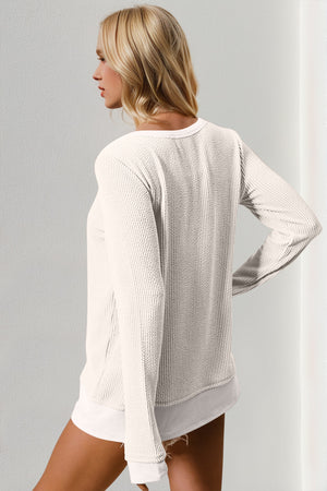 Textured crew neck thermal top in white with long sleeves and a relaxed fit.