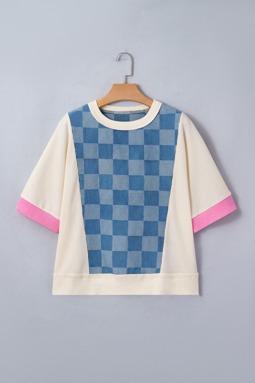 Maternity t-shirt with blue checkered denim panel, cream waffle knit, and pink sleeve cuffs.
