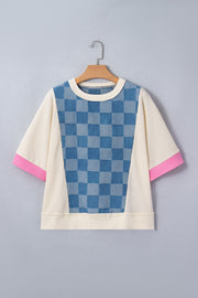 Maternity t-shirt with blue checkered denim panel, cream waffle knit, and pink sleeve cuffs.