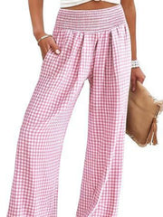 Smocked high-waist wide-leg pants in blush pink gingham with pockets.
