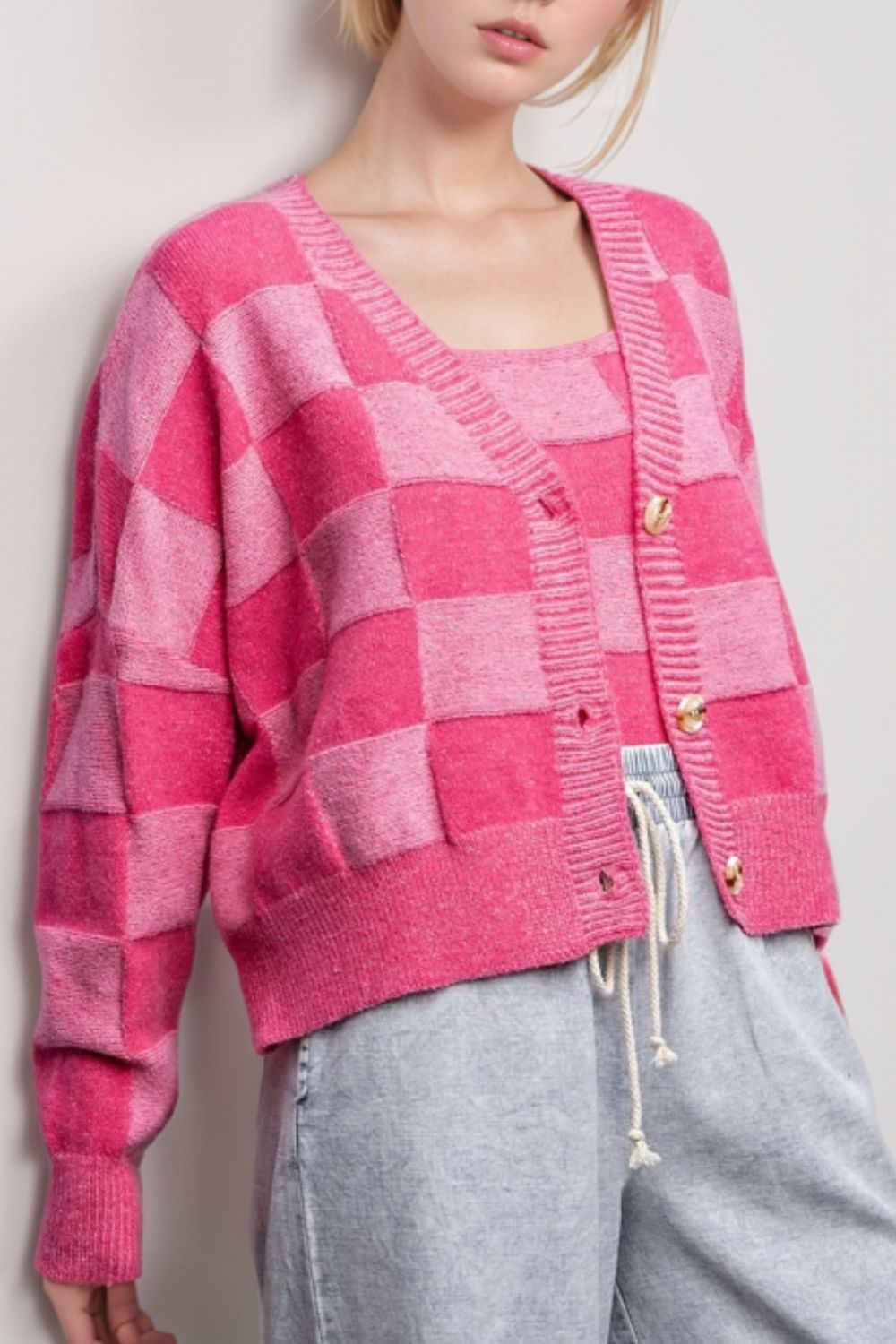Hot pink checkerboard knit cardigan with matching tank top and gold buttons.