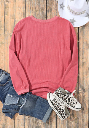 Burnt coral corduroy sweatshirt with a crew neck and long sleeves.