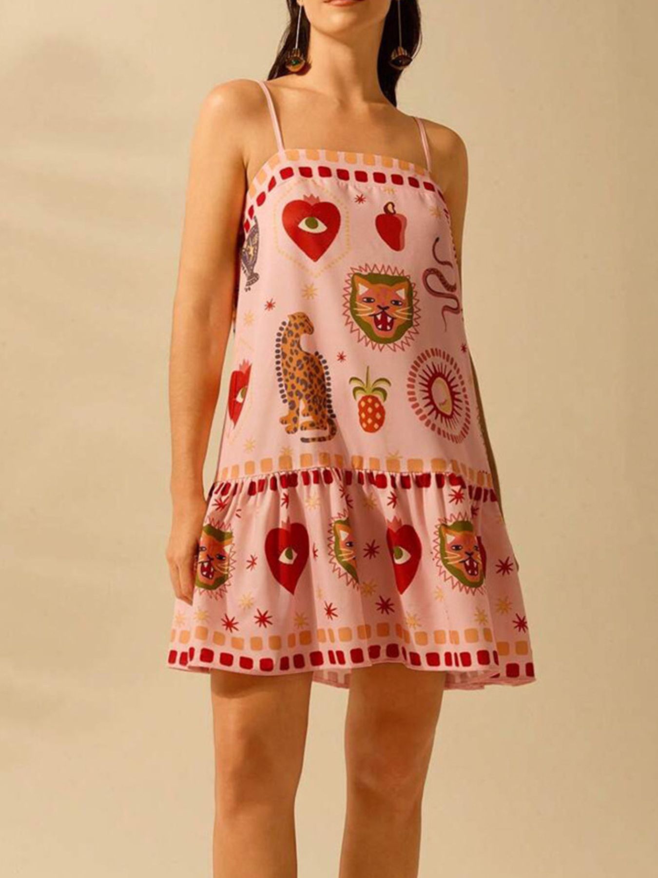 Pink mini dress with eclectic animal and heart print, ruffled hem, and square neckline.