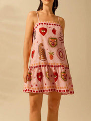 Pink mini dress with eclectic animal and heart print, ruffled hem, and square neckline.