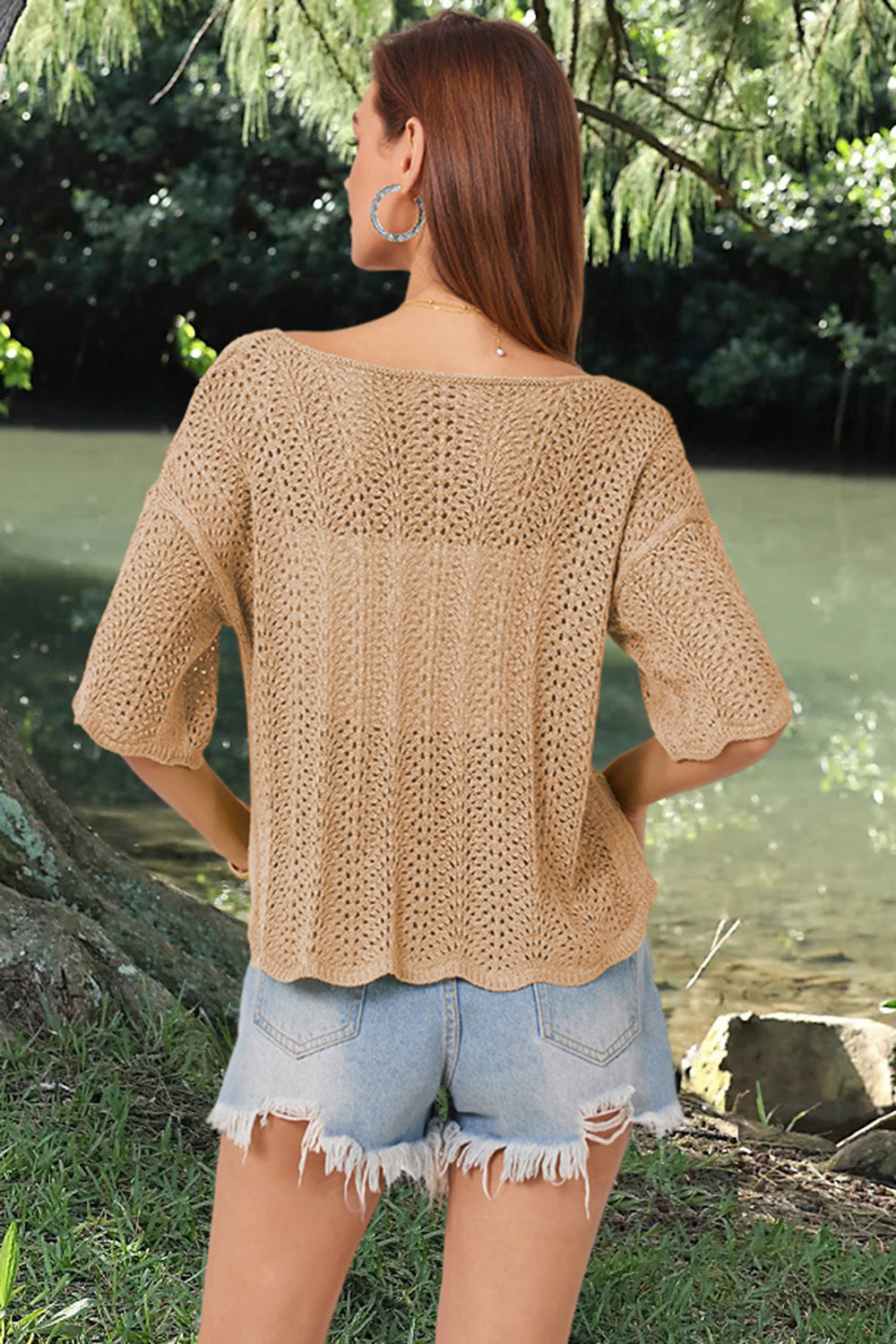 Khaki open-knit top with scalloped sleeves and a boatneck, styled with denim shorts.