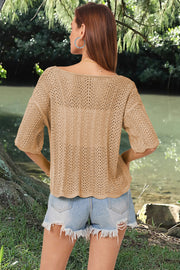 Khaki open-knit top with scalloped sleeves and a boatneck, styled with denim shorts.