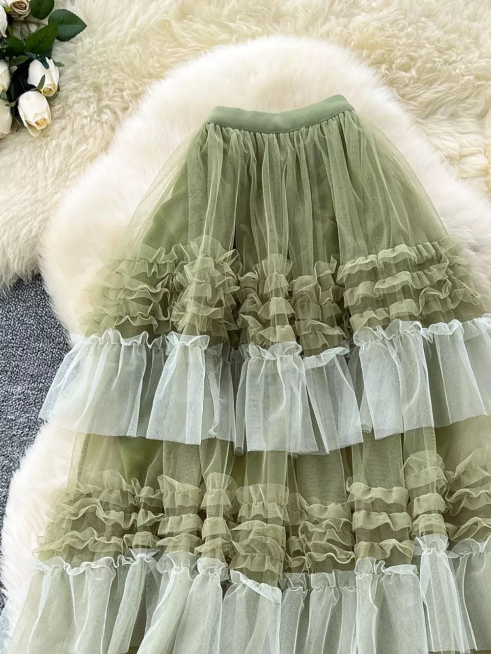Green tiered tulle skirt with ruffled tiers and a midi length.