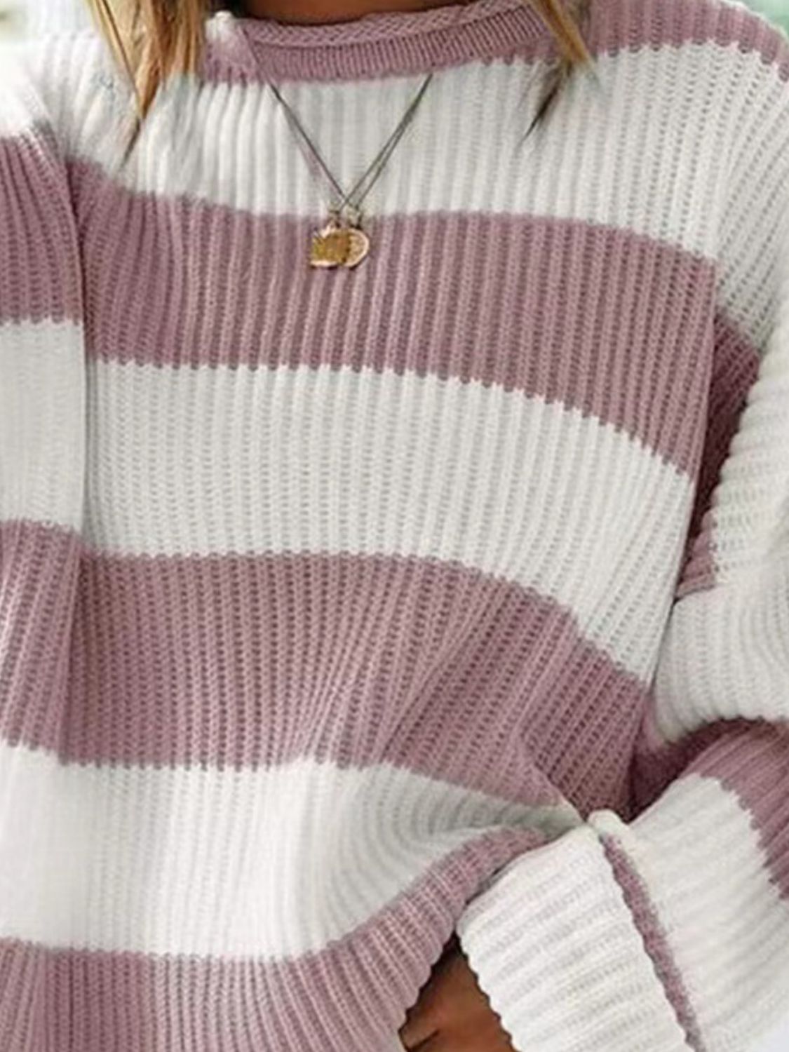 Striped oversized knit sweater in dusty pink and white with a crew neck.