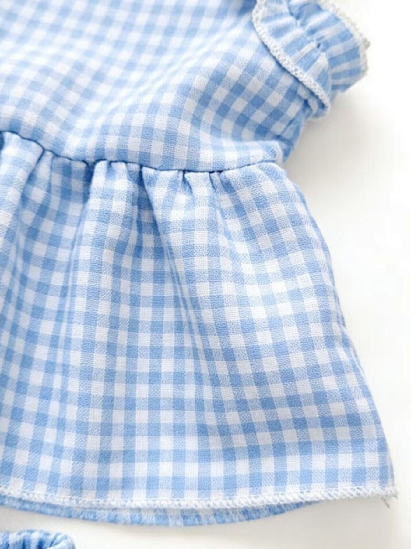 Children's light blue gingham ruffle cotton two-piece set with ruffled trim.