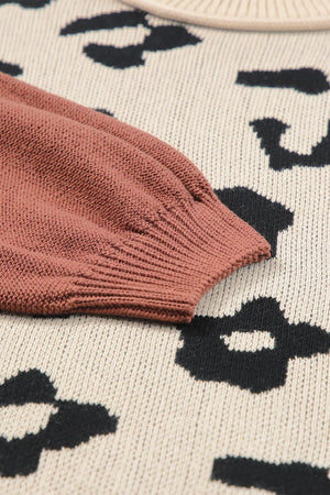 Colorblock leopard print knit sweater with a rust sleeve detail.