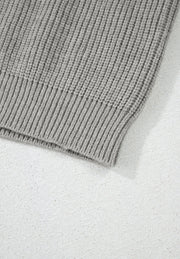 Gray ribbed knit cardigan detail showing texture and hem