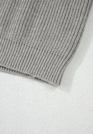 Gray ribbed knit cardigan detail showing texture and hem