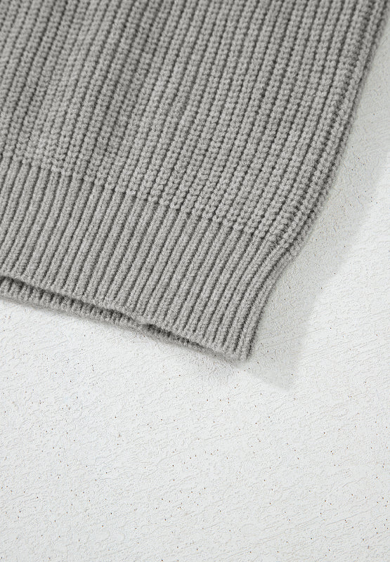 Gray ribbed knit cardigan detail showing texture and hem