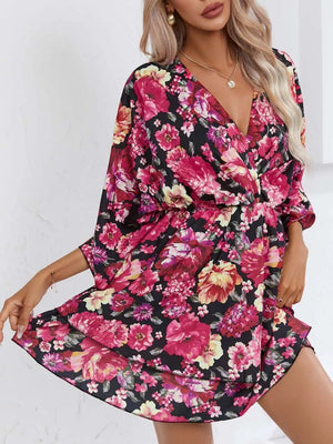 Floral ruffle hem mini dress in black with pink and yellow flowers, V-neck, 3/4 sleeves.
