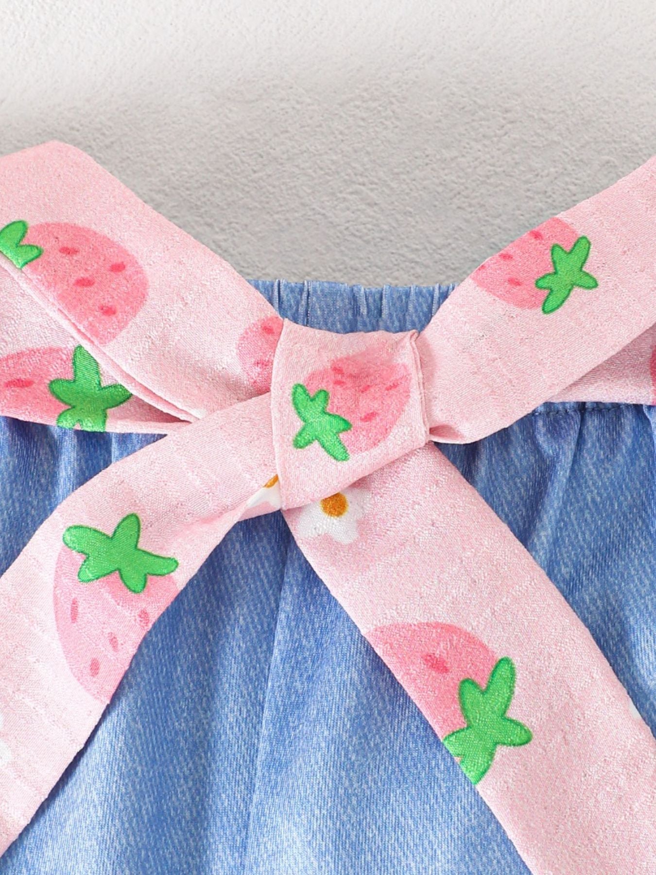 Baby cami set with strawberry print pink bow detail on blue denim shorts.