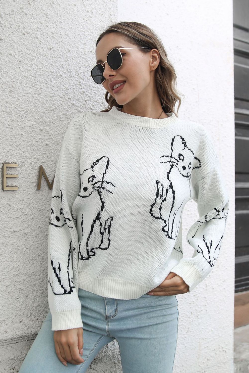 White acrylic sweater with black cat intarsia knit pattern, crew neck, long sleeves.