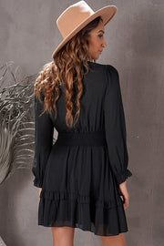 Black ruffled mini dress with smocked waist and long sleeves