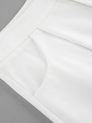 White two-piece set with snap details, featuring a pocket detail and crisp fabric.