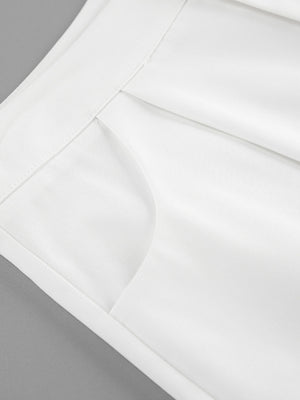 White two-piece set with snap details, featuring a pocket detail and crisp fabric.