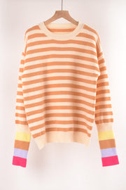 Acrylic sweater with orange and cream horizontal stripes and colorful striped cuffs.