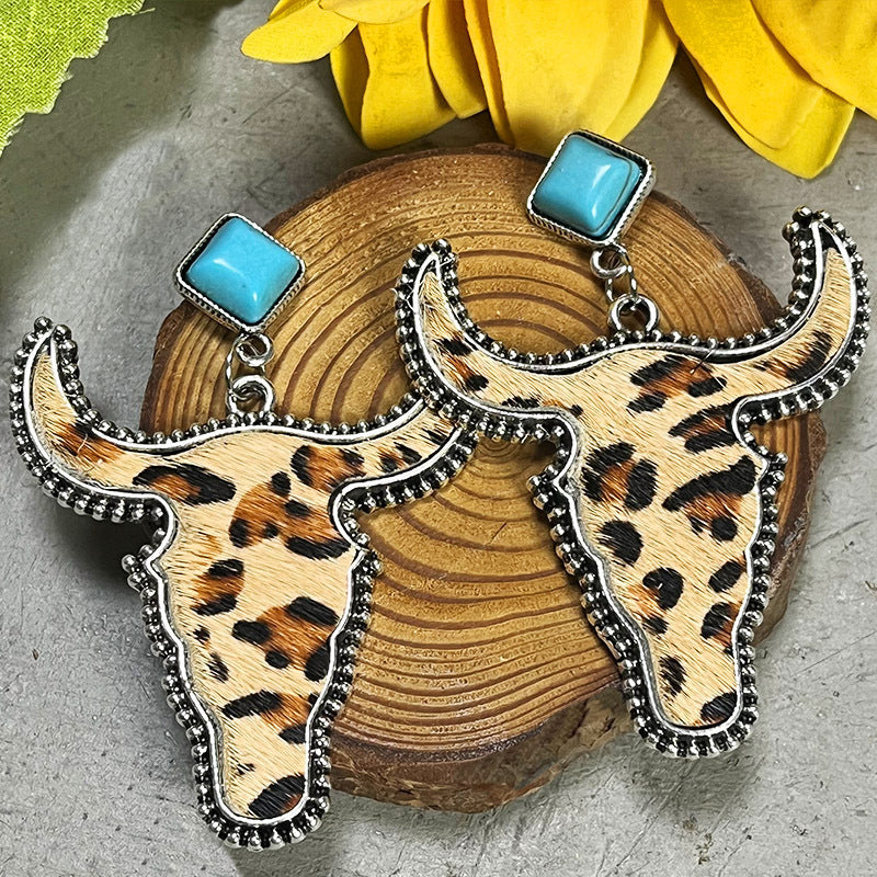Cowhide bull head earrings with leopard print and turquoise square tops.