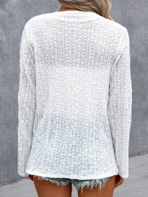 White eyelet embroidered open front cardigan with long sleeves and a delicate allover pattern.
