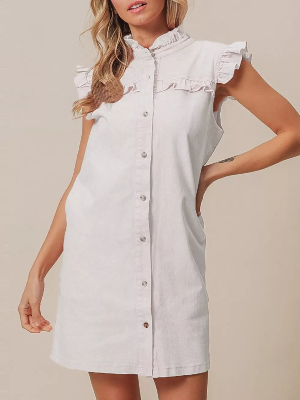 Pink denim dress with ruffled collar, cap sleeves, button-down front and pockets.