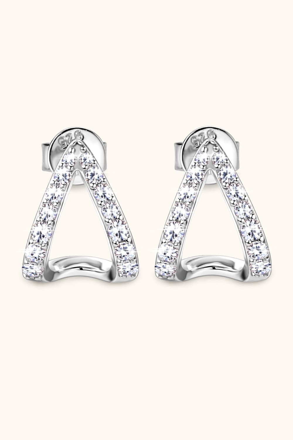 Silver geometric moissanite open-hoop earrings with pavé-set stones.
