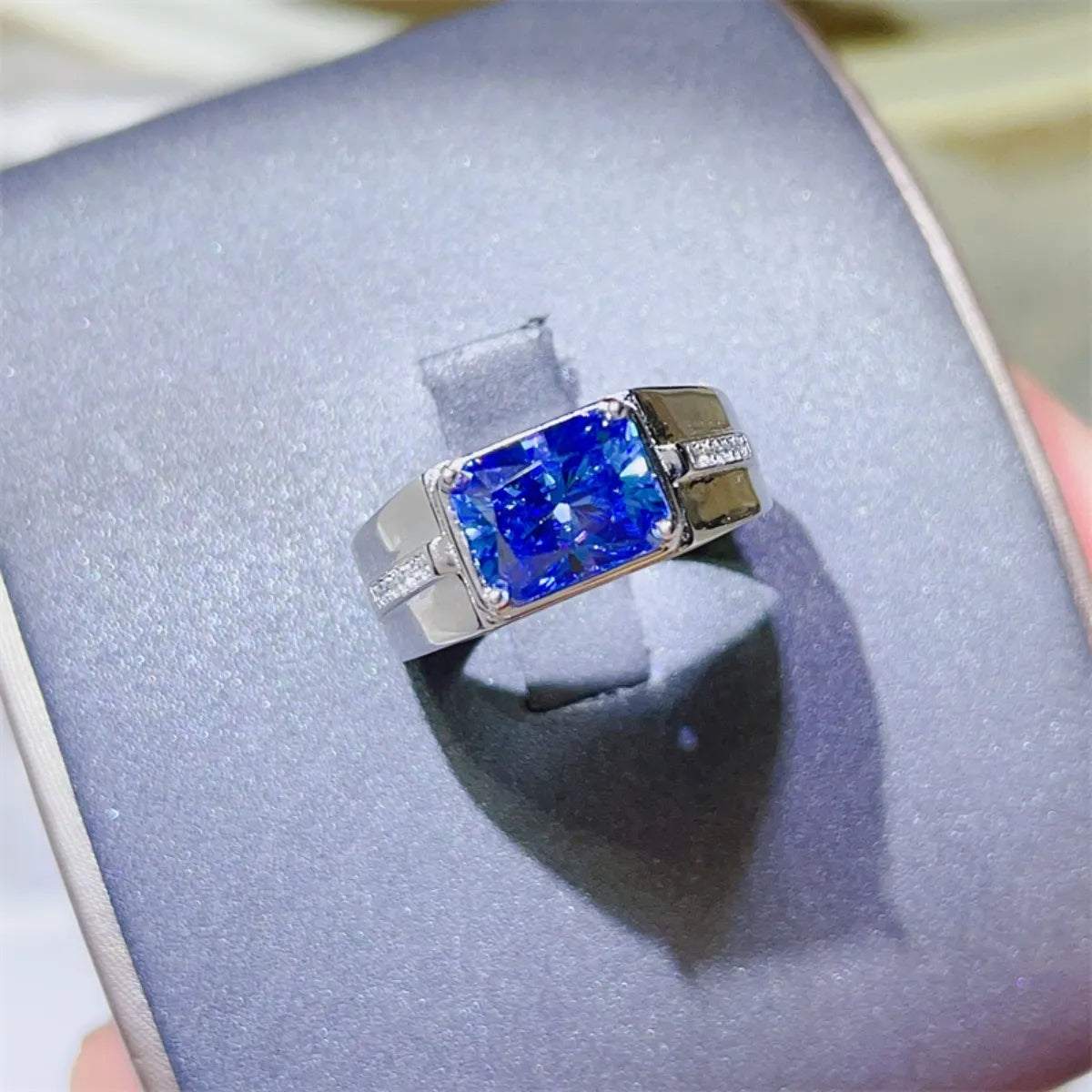 Blue emerald cut moissanite signet ring with diamond accents on band