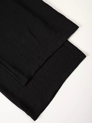 Black relaxed wide-leg maternity pants with textured fabric detail