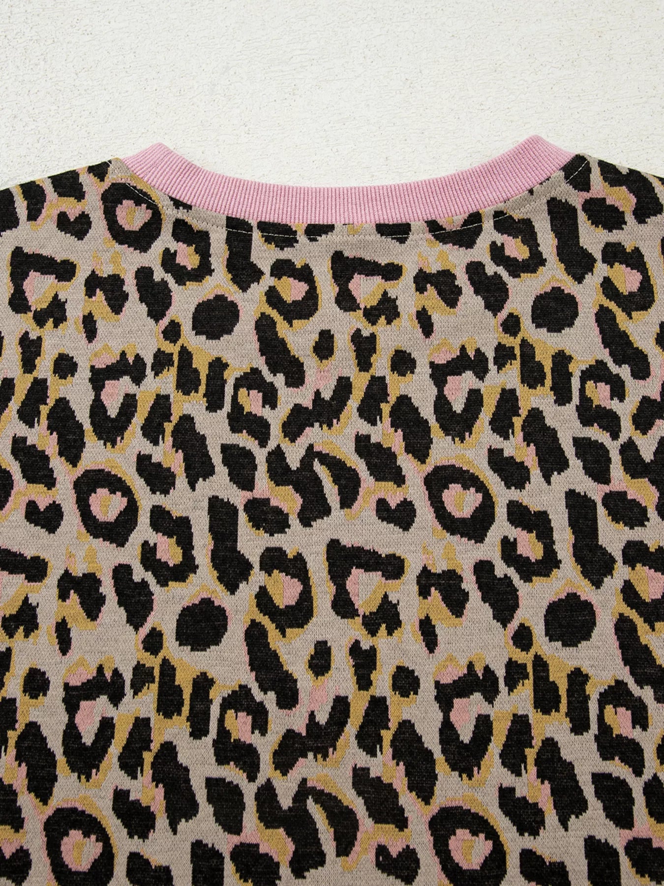 Leopard print loungewear top with pink crew neck and ribbed trim.