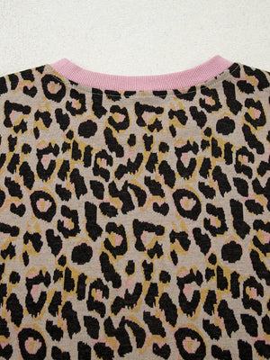 Leopard print loungewear top with pink crew neck and ribbed trim.