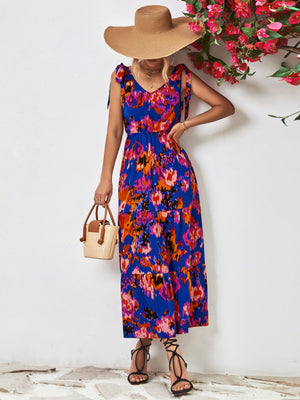 Maxi dress with abstract print, tie straps, and tiered skirt in blue and pink.