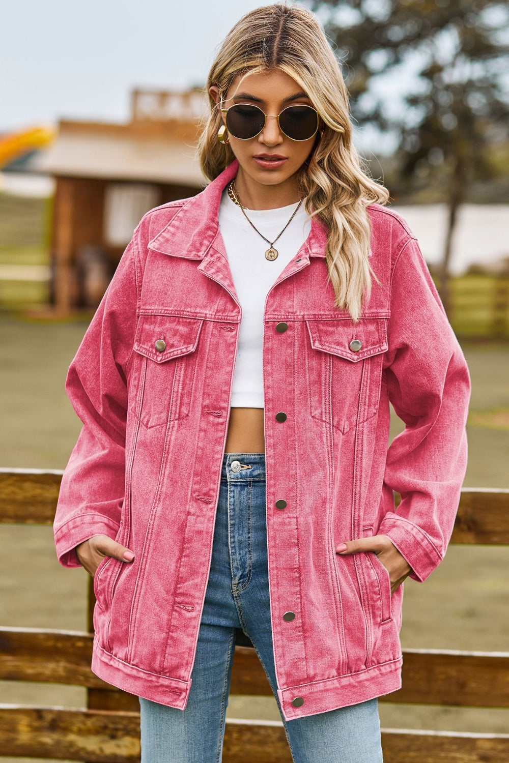 Oversized coral denim trucker jacket with classic buttoned front and chest pockets.