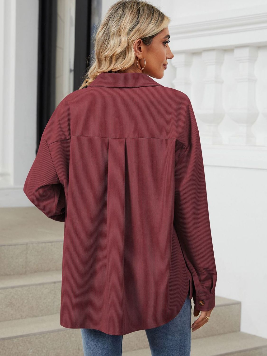 Burgundy corduroy overshirt with buttoned cuffs and back pleats.