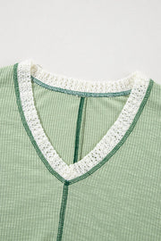 Textured patchwork tunic in gum leaf green with white lace trim and contrast stitching.