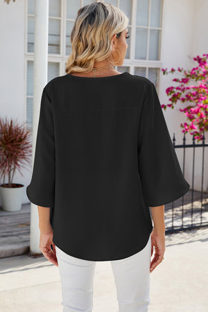 Black asymmetric sleeve blouse with a relaxed fit and curved hem.