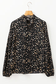 Black high-neck abstract print blouse with long sleeves and button closure at back neck.