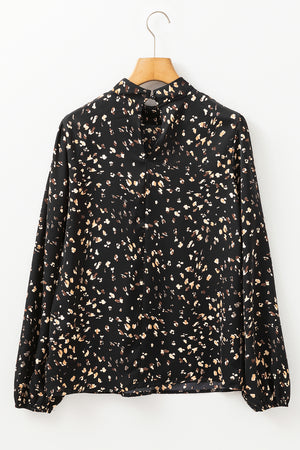 Black high-neck abstract print blouse with long sleeves and button closure at back neck.