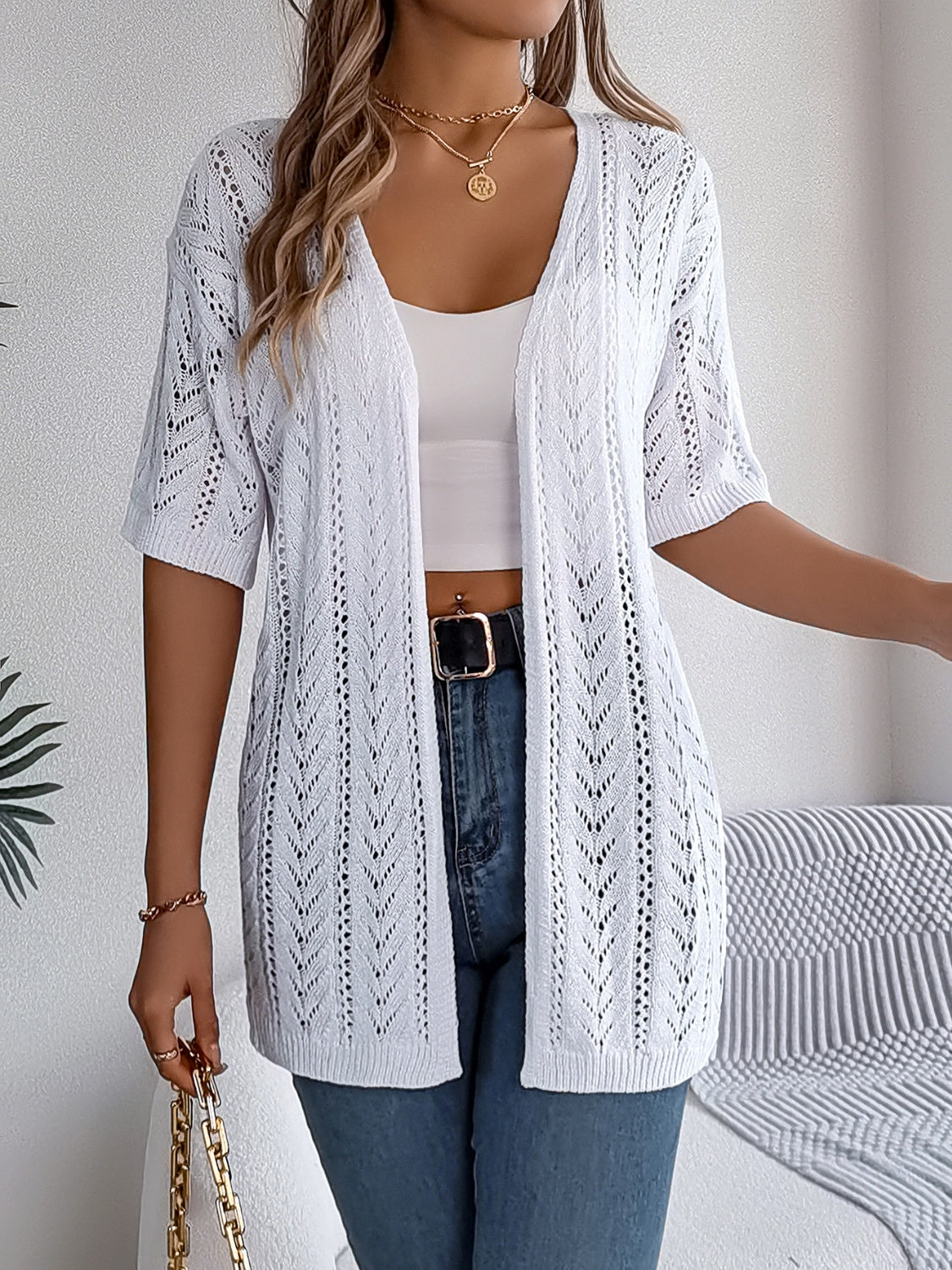 White open-knit chevron sleeve cardigan with short sleeves and an open front.