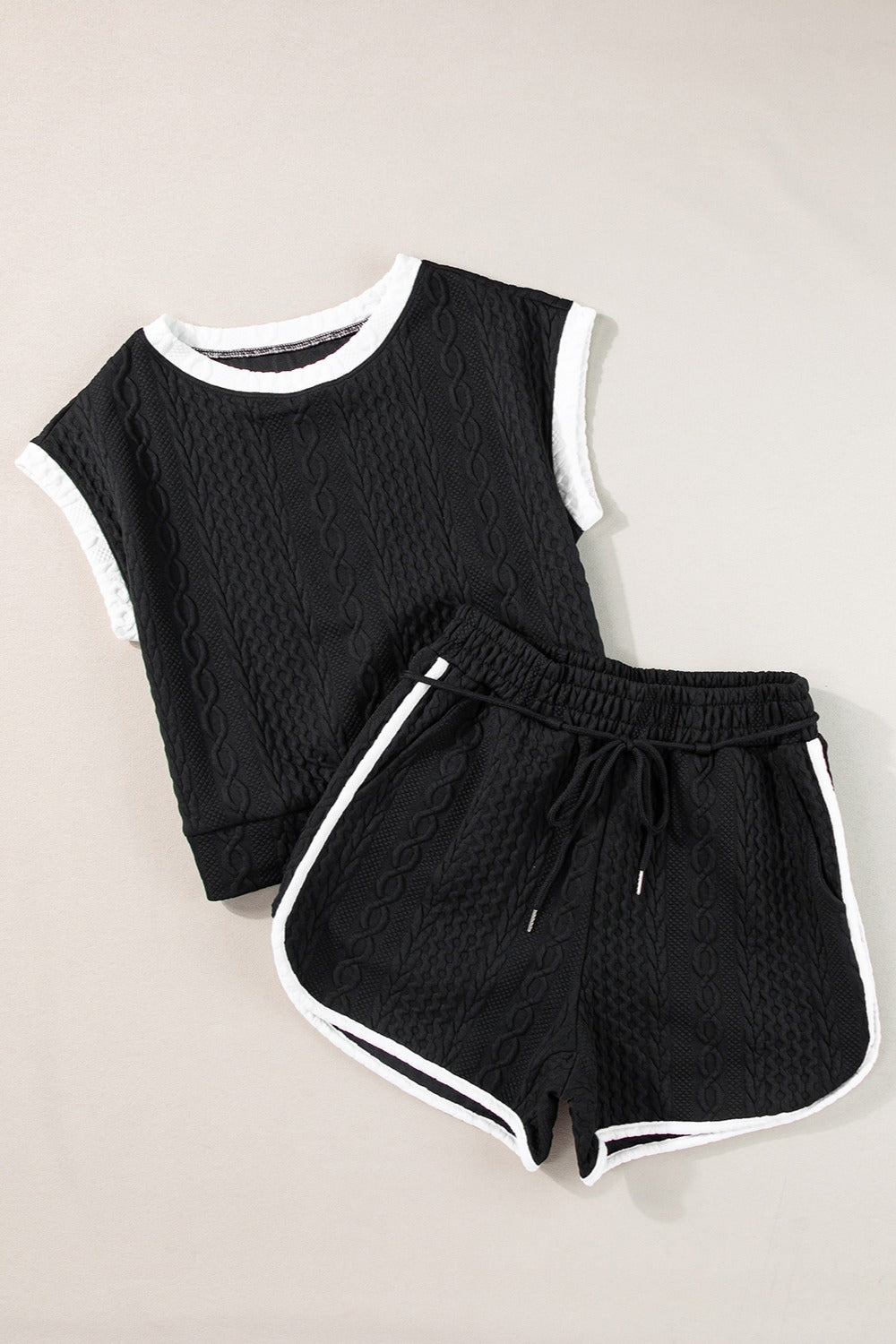 Black textured knit loungewear set with contrast trim and drawstring shorts