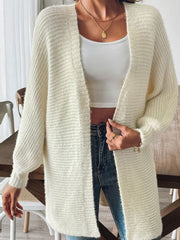 Cream ribbed knit dolman sleeve cardigan with open front and textured sleeves.